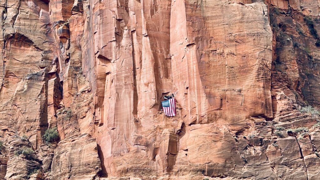 Joe, Sam, and Sylvan mount American Flag High above Zion National Park on Moonlight Buttress